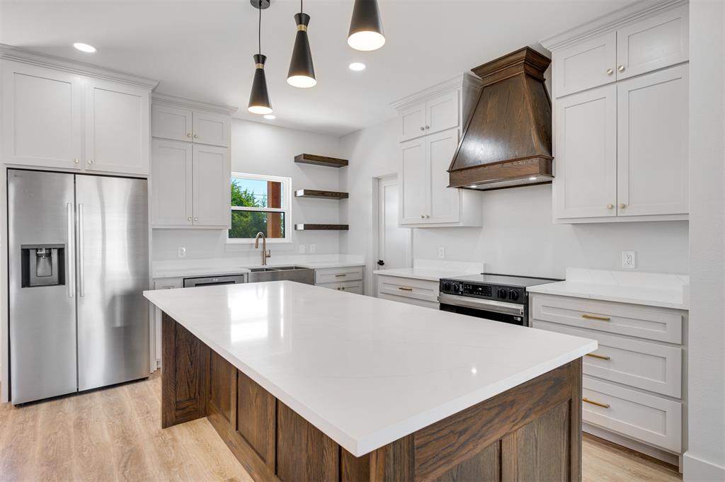 406 Private Road Brookston, TX 75421 - Photo 10 of 37 a kitchen with stainless steel appliances a sink stove and refrigerator