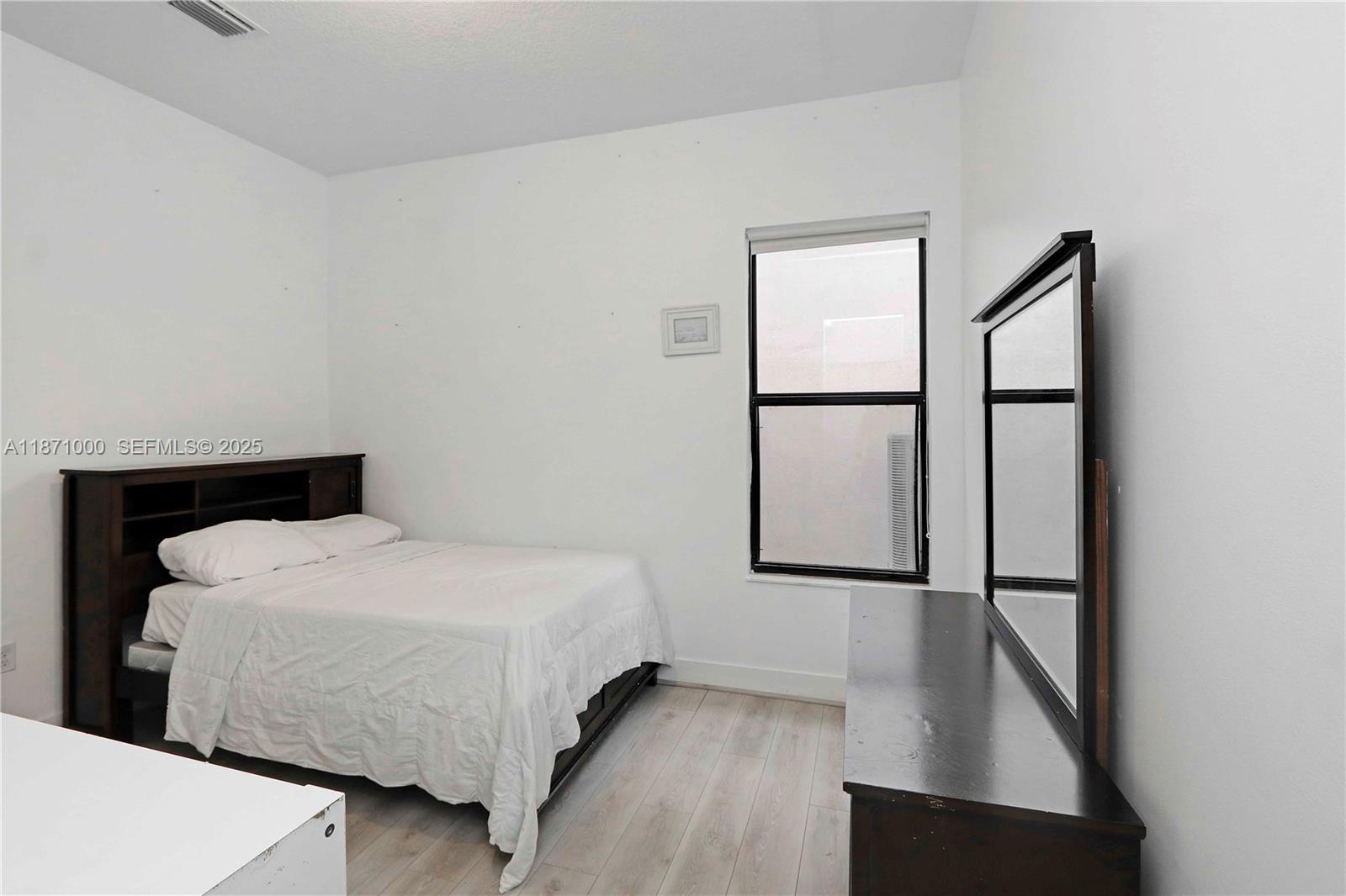 3293 West 98th Place Hialeah, FL 33018 - Photo 11 of 49 a bedroom with a bed and a window