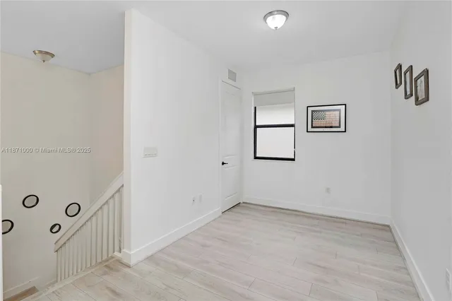 a bedroom with a bed and a chair in it