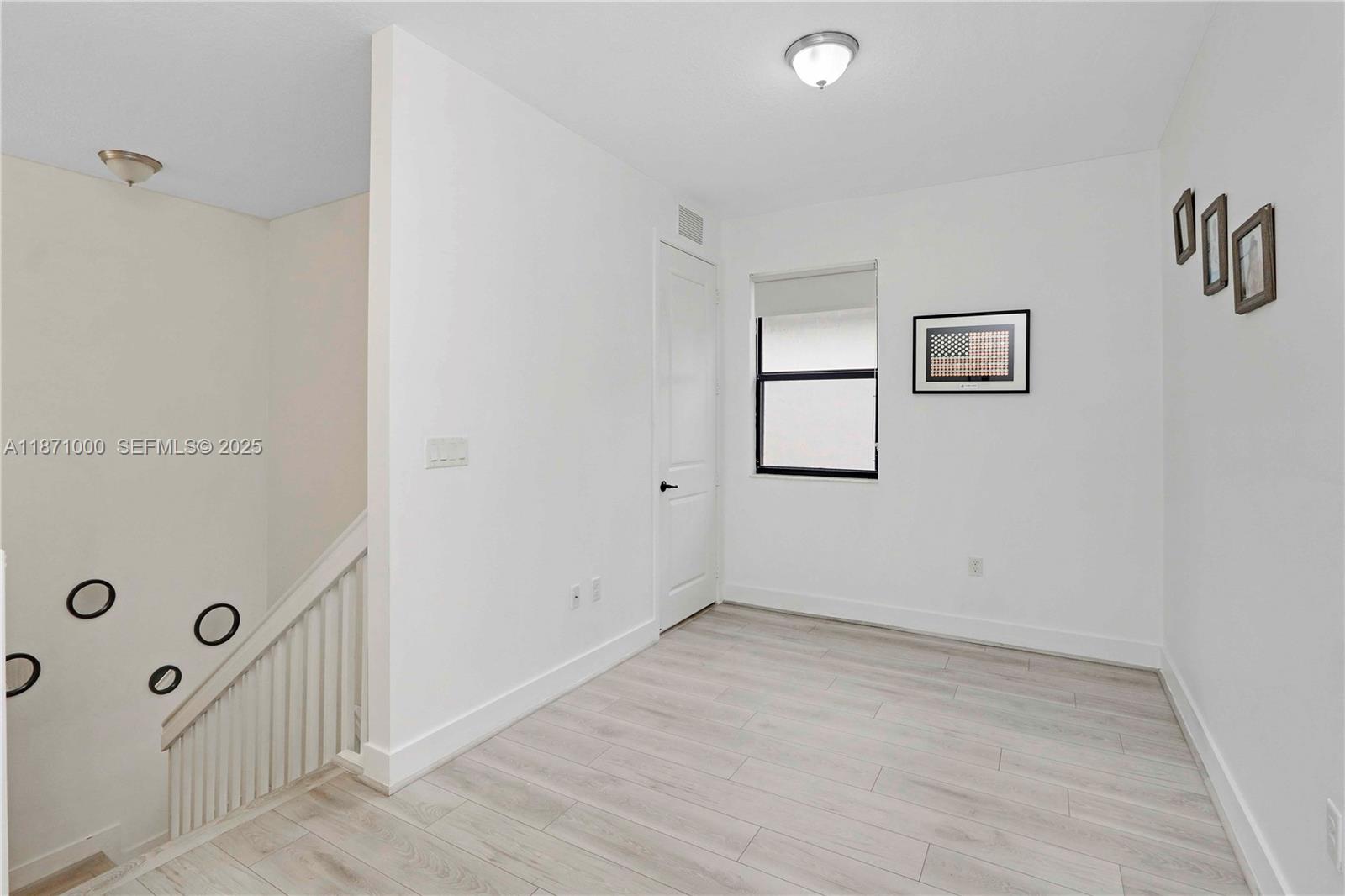 3293 West 98th Place Hialeah, FL 33018 - Photo 15 of 49 a view of a room with wooden floor and window