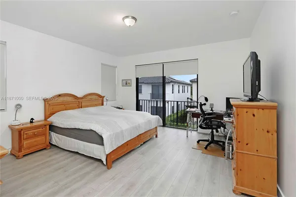 a bedroom with a bed and a chair in it