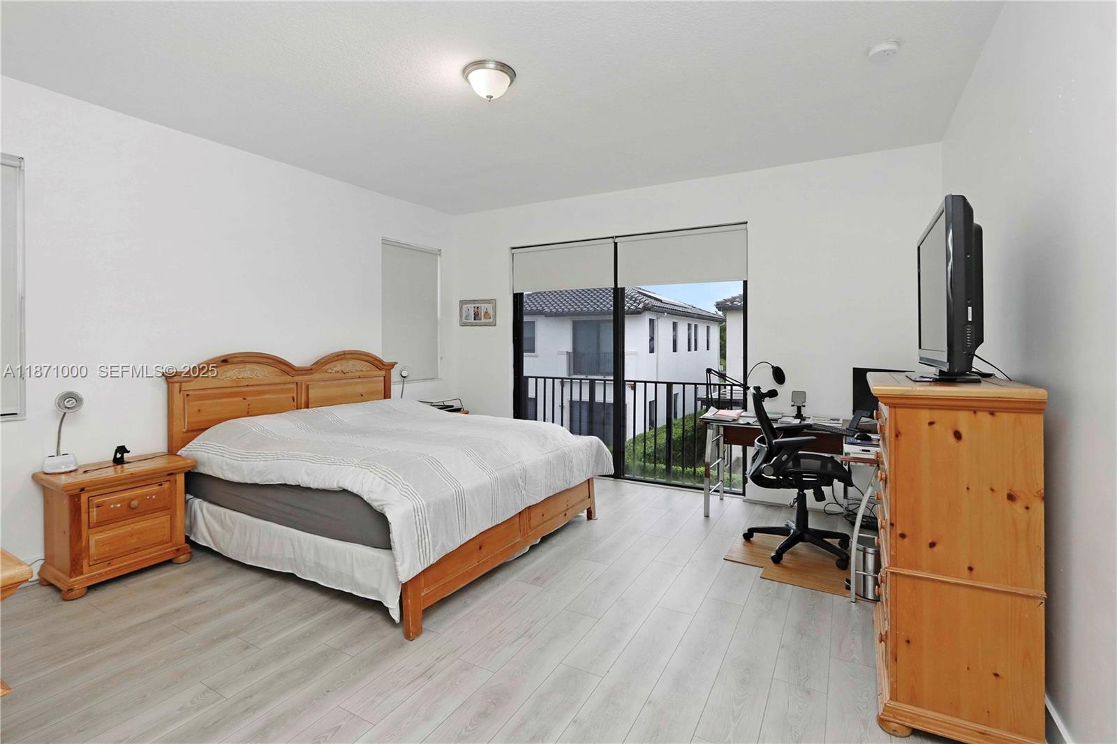 3293 West 98th Place Hialeah, FL 33018 - Photo 16 of 49 a bedroom with a bed and a chair in it