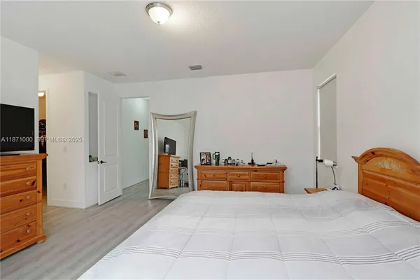 a bedroom with furniture and natural light