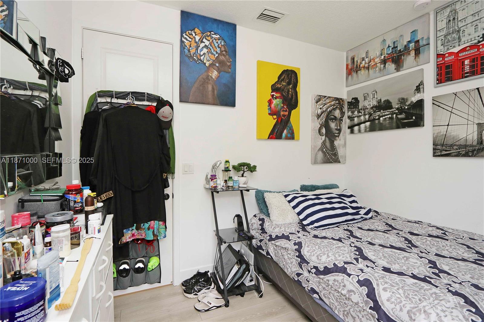 3293 West 98th Place Hialeah, FL 33018 - Photo 22 of 49 a view of walk in closet with clothes and shoes