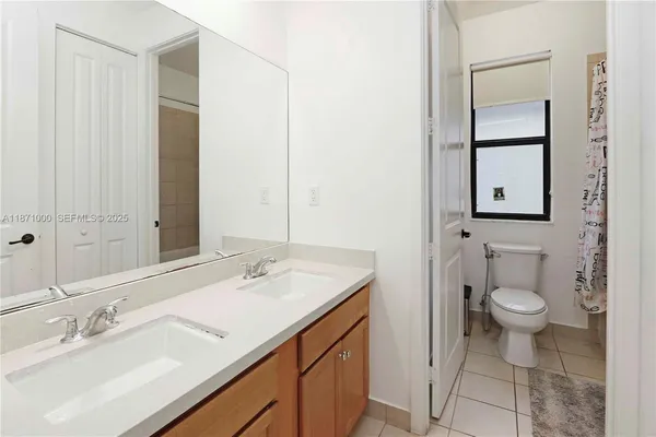 a bathroom with a sink toilet and mirror