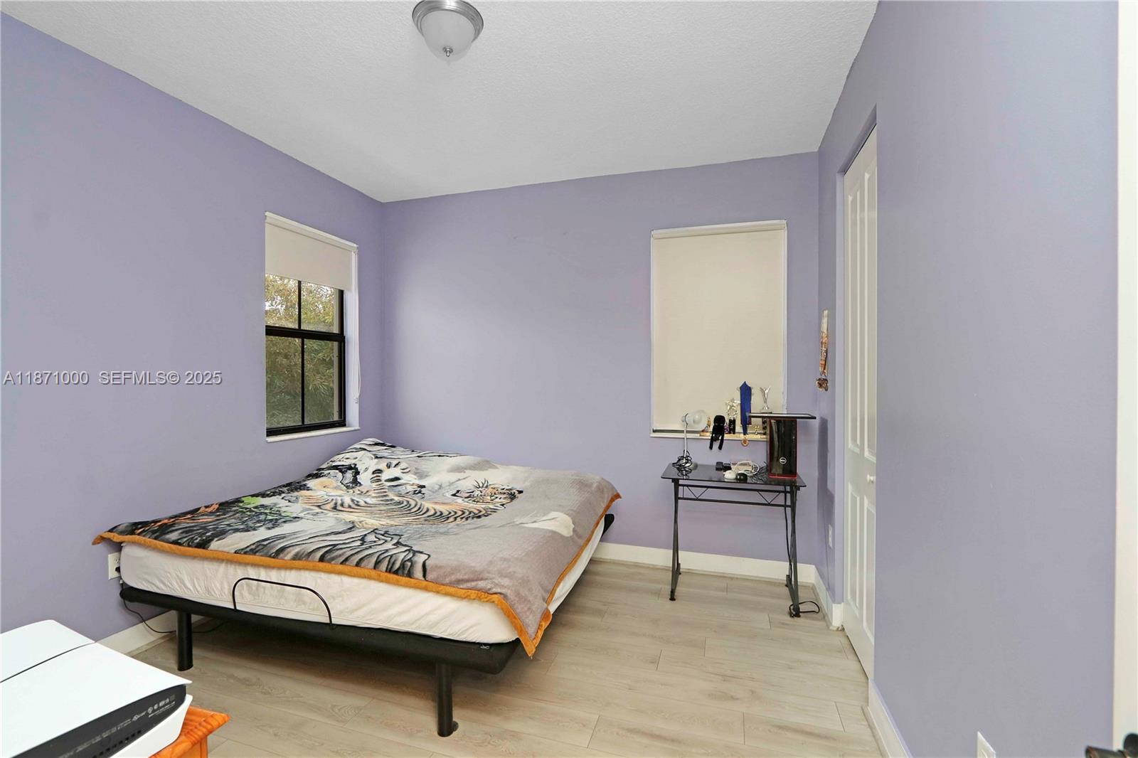 3293 West 98th Place Hialeah, FL 33018 - Photo 25 of 49 a bedroom with a bed and chair