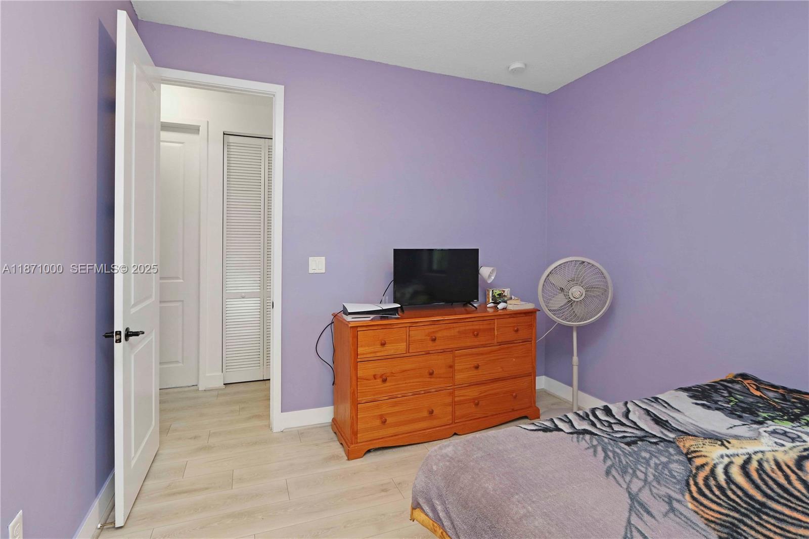 3293 West 98th Place Hialeah, FL 33018 - Photo 26 of 49 a bedroom with a bed and wooden floor