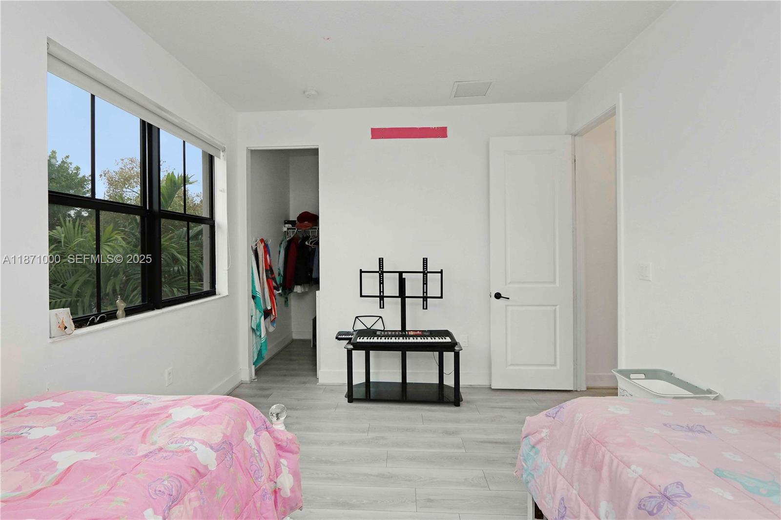 3293 West 98th Place Hialeah, FL 33018 - Photo 28 of 49 a bedroom with a bed and a large window