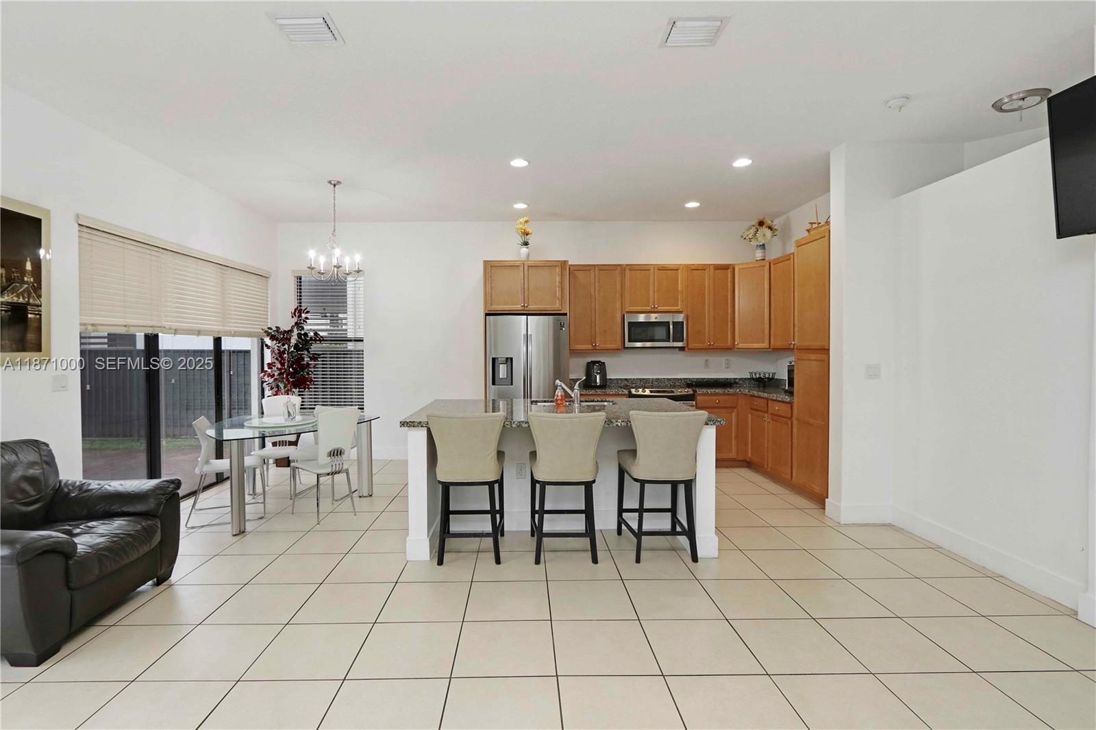 3293 West 98th Place Hialeah, FL 33018 - Photo 4 of 49 a large kitchen with cabinets table and chairs
