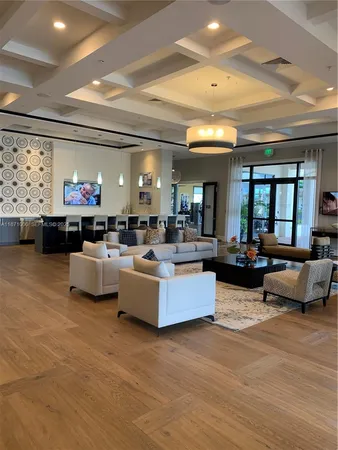 a living room with furniture kitchen and a chandelier