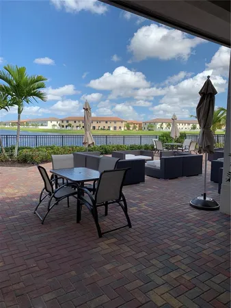 a view of a terrace with furniture and a garden