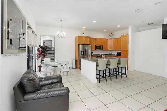 a living room with furniture and kitchen view
