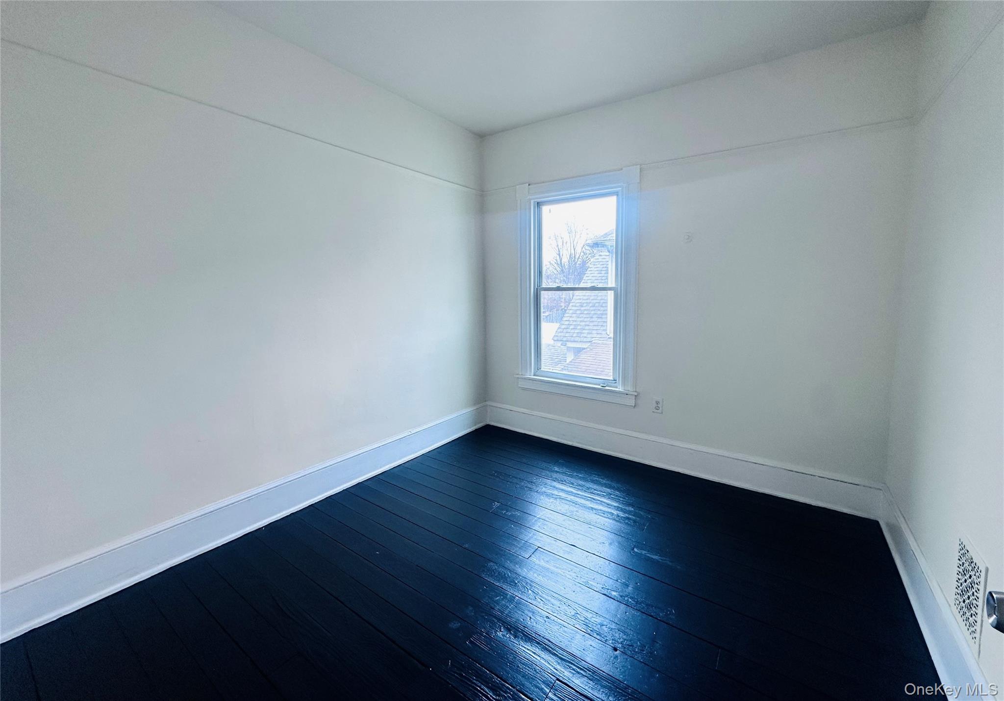 80 North Hamilton Street, Unit 2 Poughkeepsie, NY 12601 - Photo 11 of 17 an empty room with wooden floor and window
