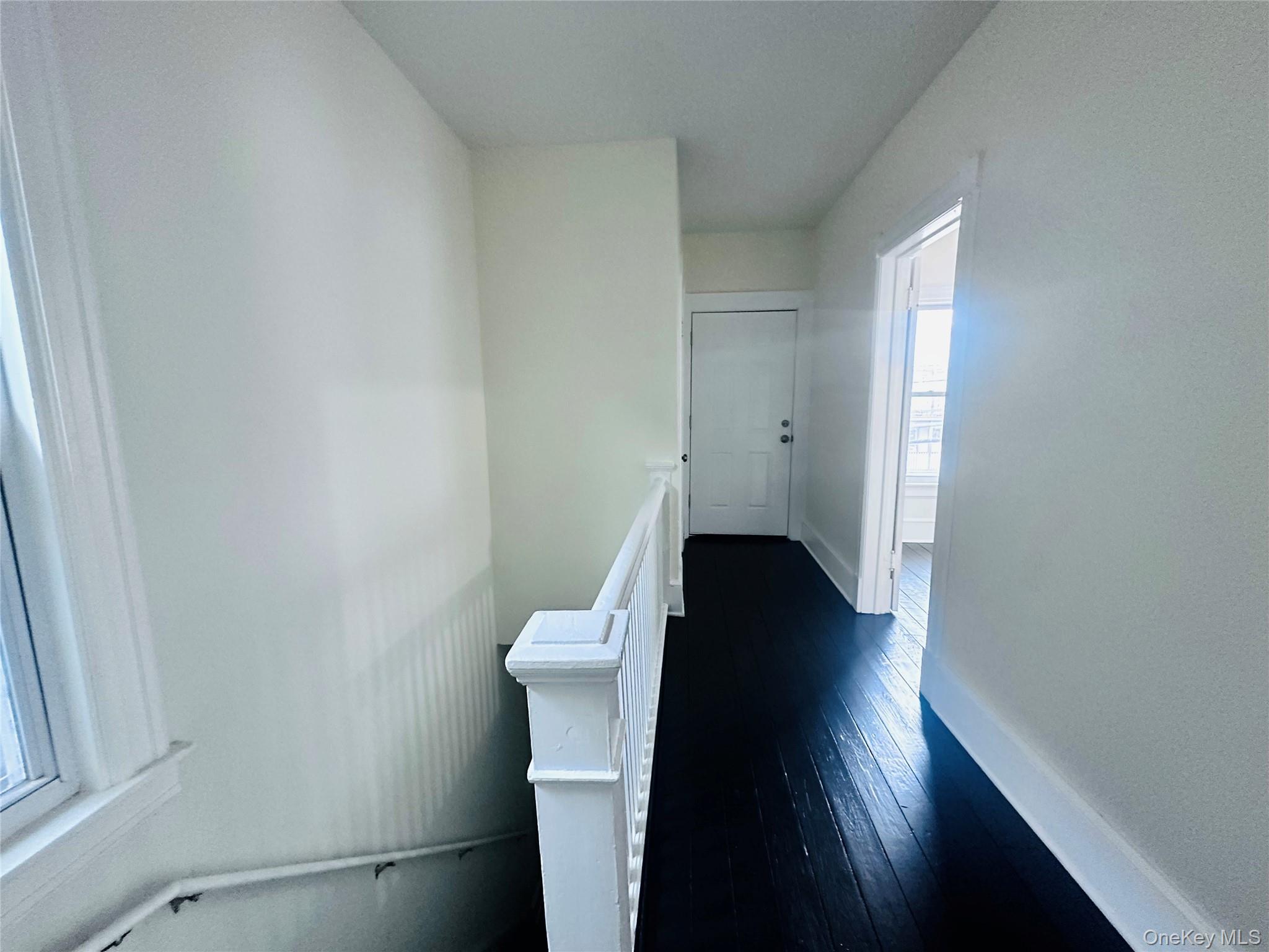 80 North Hamilton Street, Unit 2 Poughkeepsie, NY 12601 - Photo 13 of 17 a view of a hallway with wooden floor and a bathroom