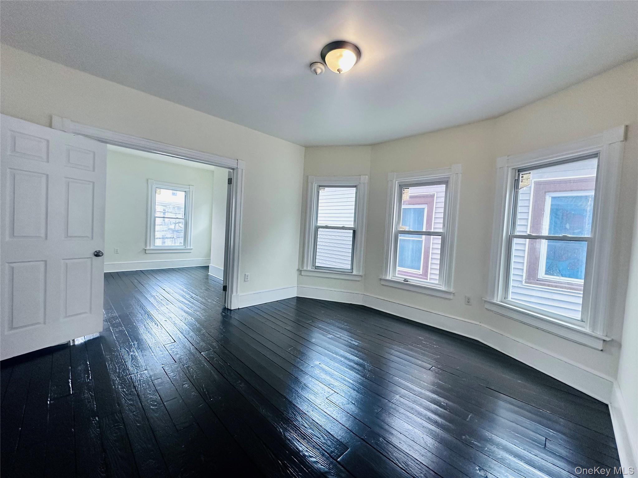 80 North Hamilton Street, Unit 2 Poughkeepsie, NY 12601 - Photo 5 of 17 a view of an empty room with wooden floor and a window