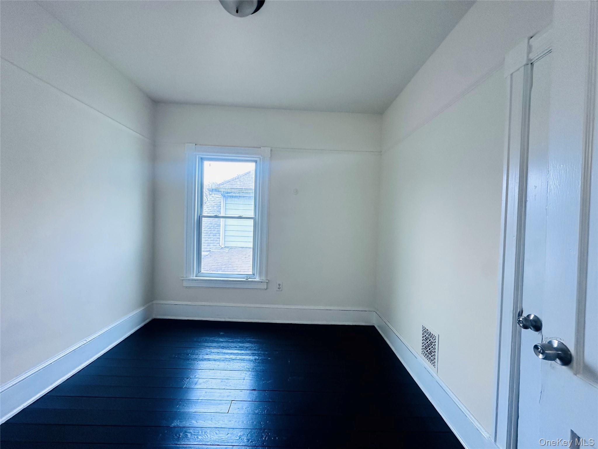 80 North Hamilton Street, Unit 2 Poughkeepsie, NY 12601 - Photo 10 of 17 an empty room with wooden floor and windows