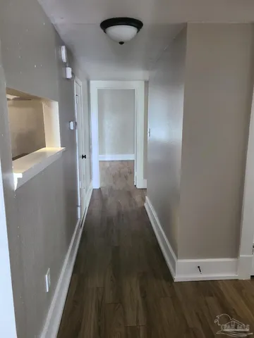 a view of hallway with wooden floor