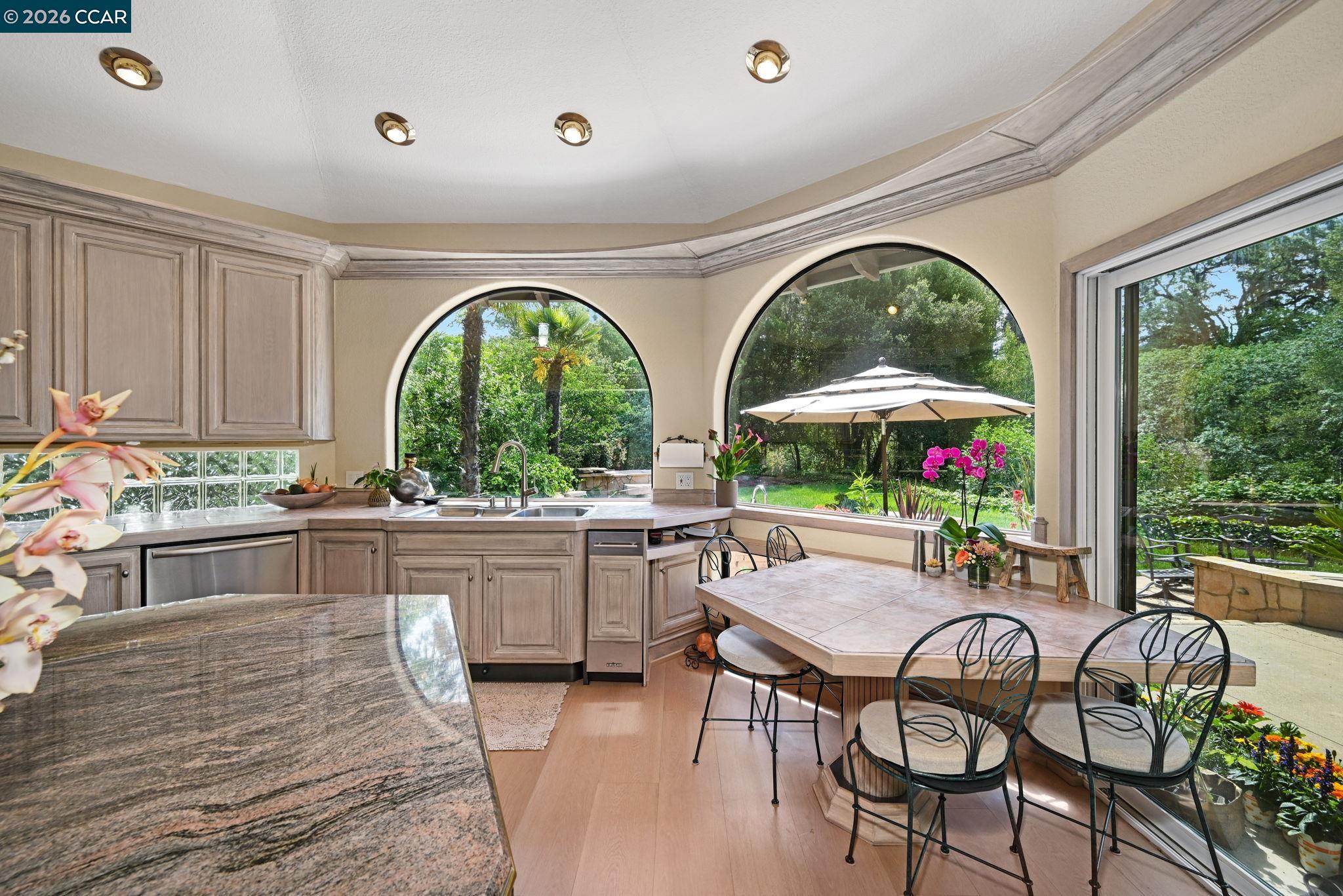 490 St Marys Road Lafayette, CA 94549 - Photo 19 of 61 a kitchen with stainless steel appliances granite countertop a table and chairs in it