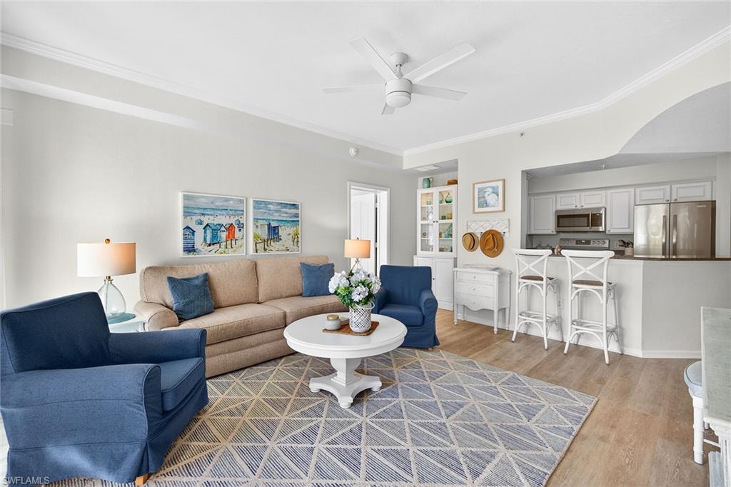 a living room with furniture a dining table and kitchen view