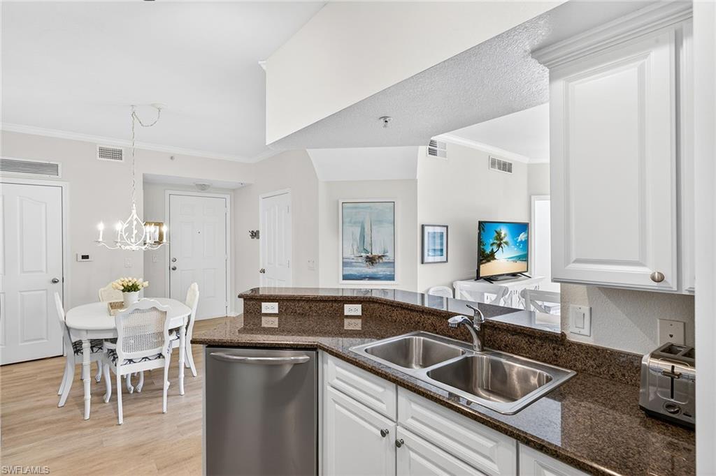 12950 Positano Circle, Unit 101 Naples, FL 34105 - Photo 12 of 34 a kitchen with a sink and cabinets