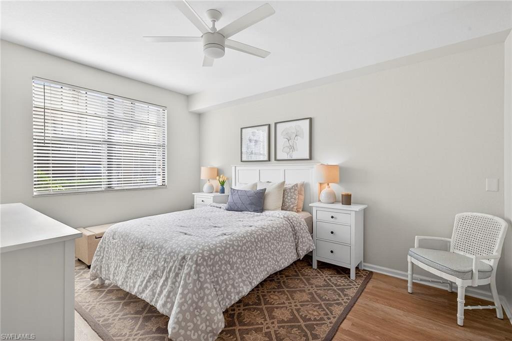 12950 Positano Circle, Unit 101 Naples, FL 34105 - Photo 14 of 34 a bedroom with a bed and a window