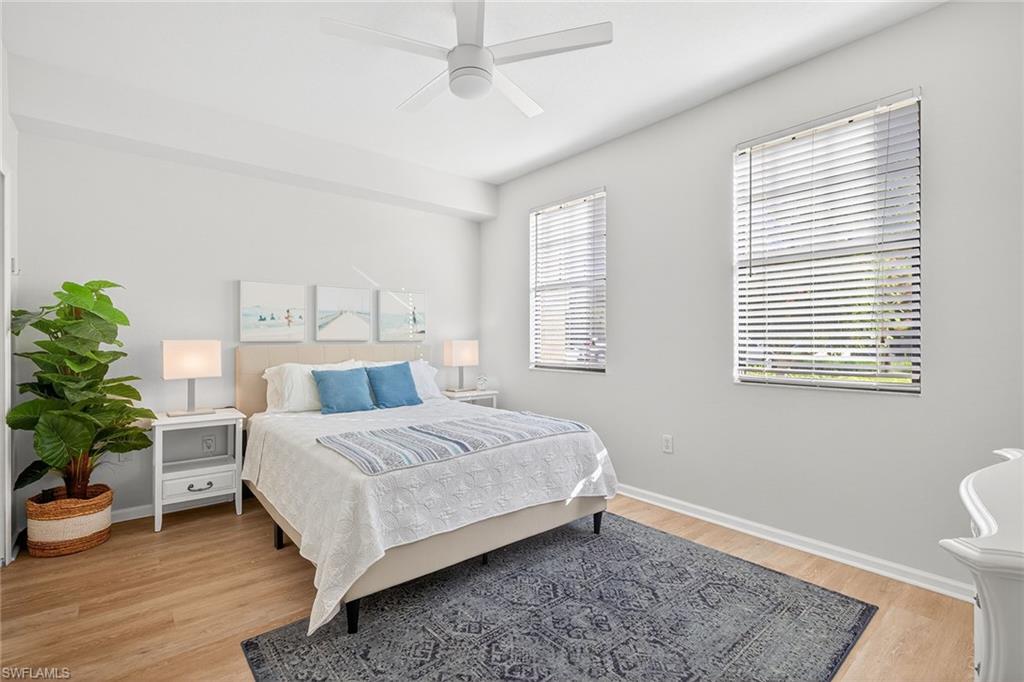 12950 Positano Circle, Unit 101 Naples, FL 34105 - Photo 18 of 34 a bedroom with a bed and a potted plant