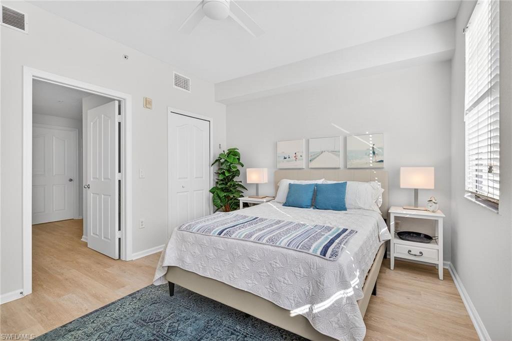 12950 Positano Circle, Unit 101 Naples, FL 34105 - Photo 20 of 34 a bedroom with a bed and a window