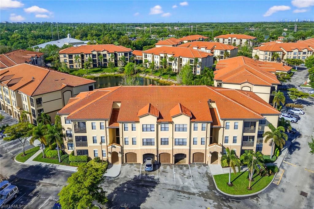 12950 Positano Circle, Unit 101 Naples, FL 34105 - Photo 26 of 34 an aerial view of a house with garden space and lake view