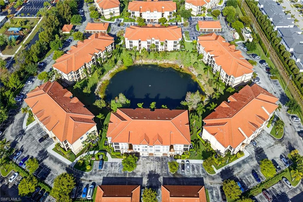 12950 Positano Circle, Unit 101 Naples, FL 34105 - Photo 27 of 34 an aerial view of residential houses with outdoor space