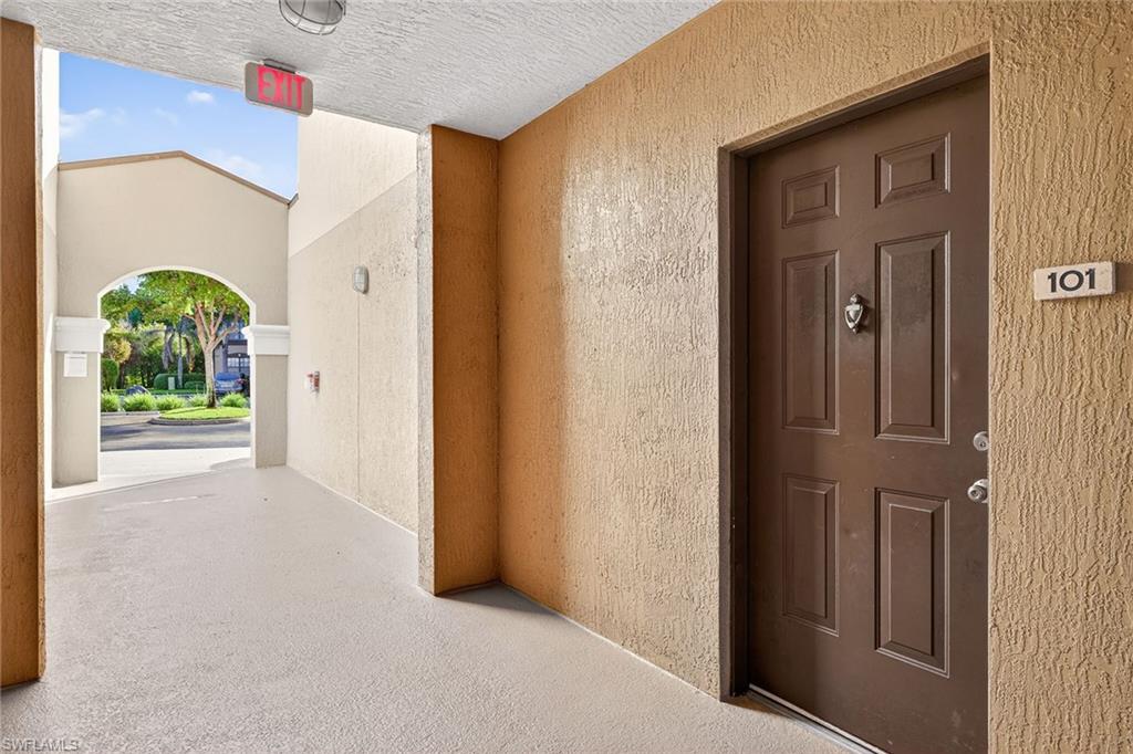 12950 Positano Circle, Unit 101 Naples, FL 34105 - Photo 30 of 34 a view of a hallway with entryway door