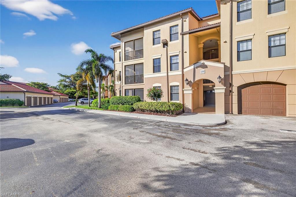 12950 Positano Circle, Unit 101 Naples, FL 34105 - Photo 3 of 34 a view of a building with a street