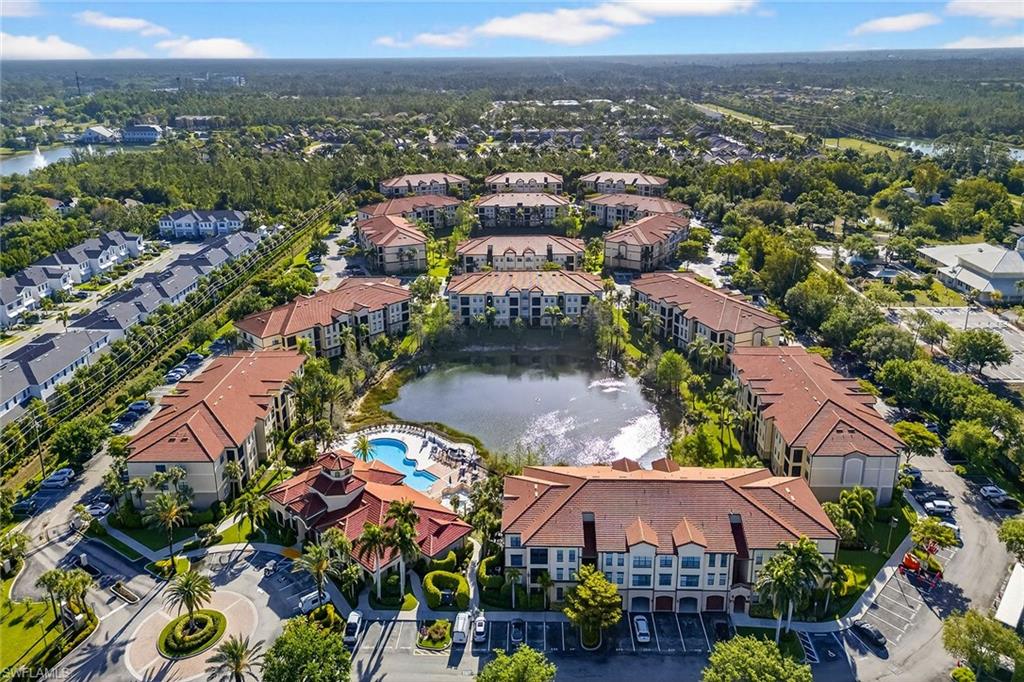 12950 Positano Circle, Unit 101 Naples, FL 34105 - Photo 33 of 34 an aerial view of residential houses with outdoor space