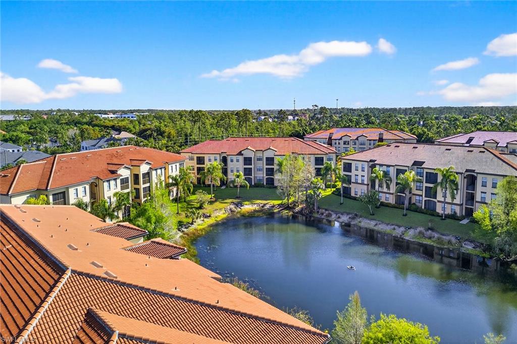 12950 Positano Circle, Unit 101 Naples, FL 34105 - Photo 34 of 34 a view of a lake with a garden