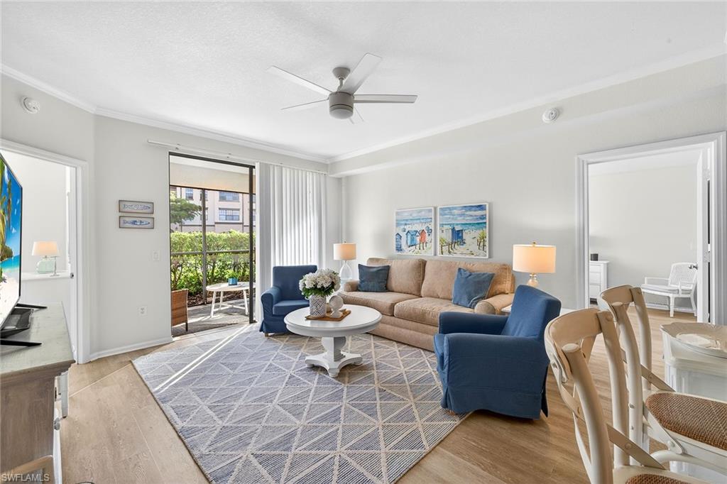 12950 Positano Circle, Unit 101 Naples, FL 34105 - Photo 4 of 34 a living room with furniture and a window