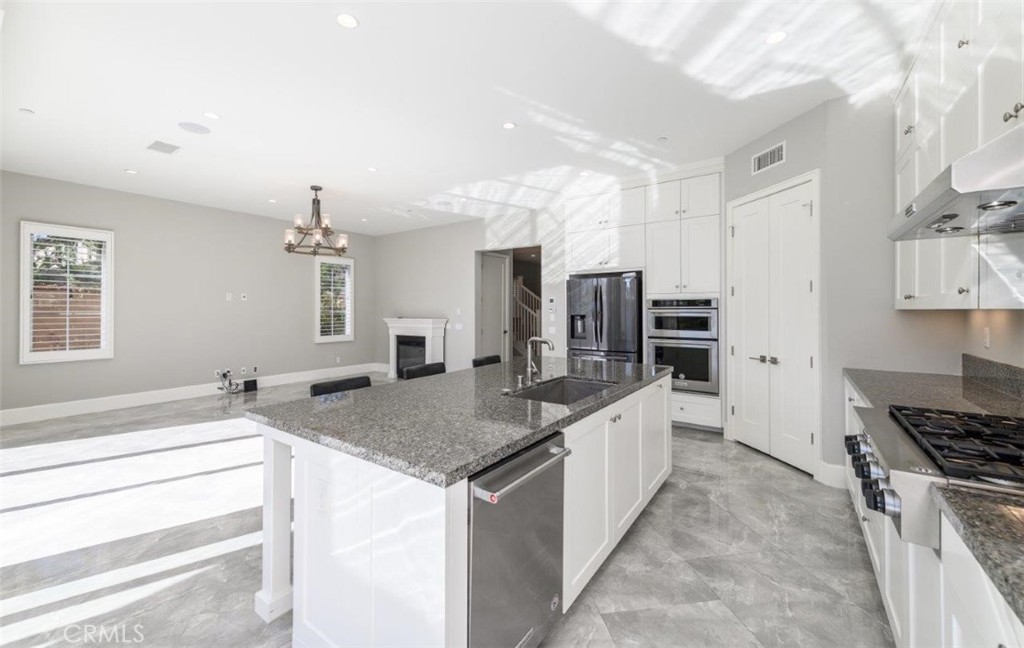 100 Rusina Irvine, CA 92602 - Photo 15 of 46 a large kitchen with kitchen island a sink stove and refrigerator