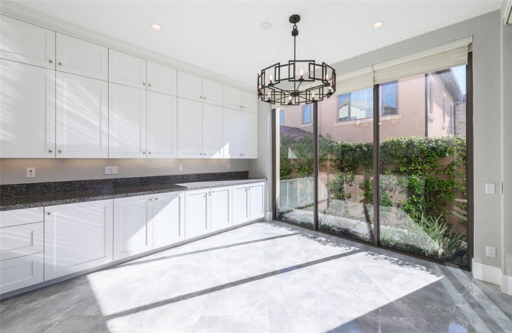 100 Rusina Irvine, CA 92602 - Photo 20 of 46 a view of a kitchen with a refrigerator cabinets and a counter top space