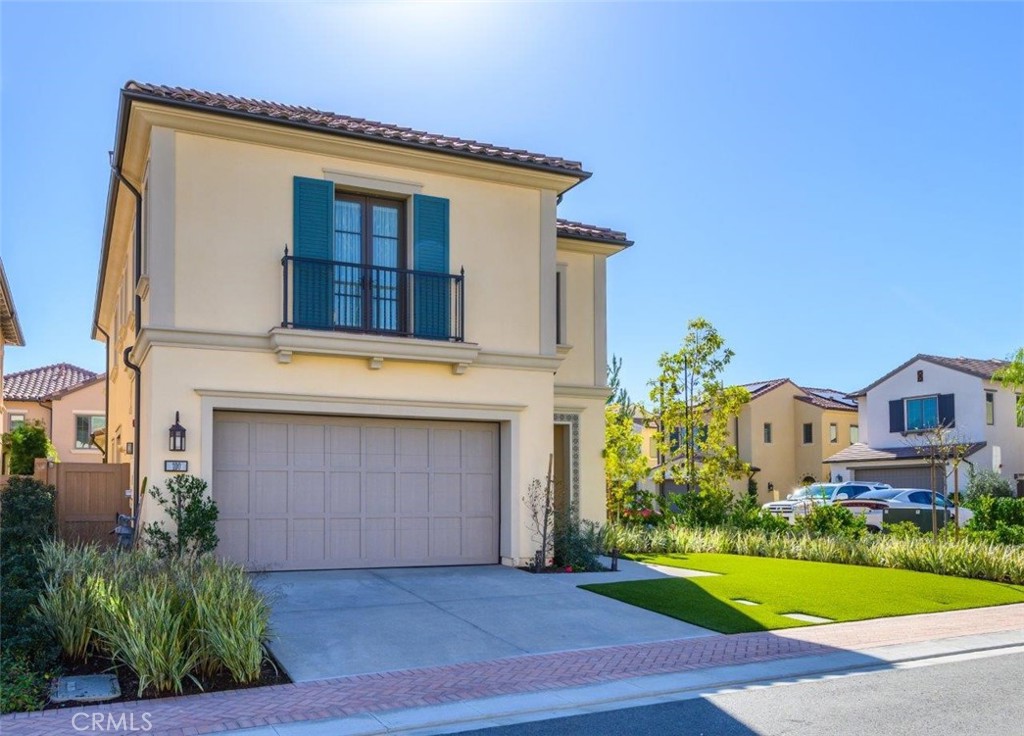 100 Rusina Irvine, CA 92602 - Photo 2 of 46 a front view of a house with a yard and garage