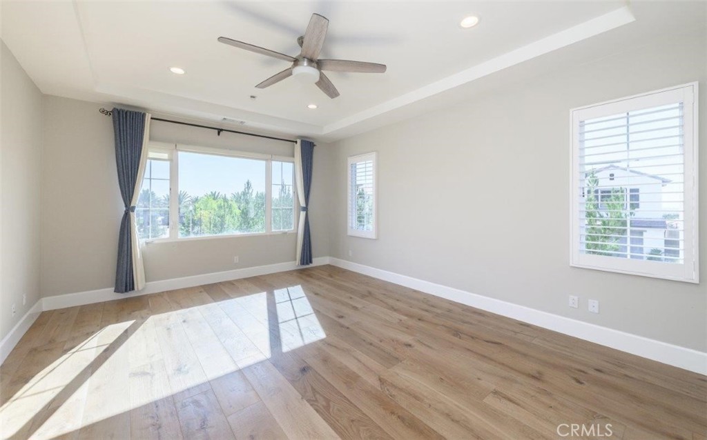 100 Rusina Irvine, CA 92602 - Photo 23 of 46 a view of an empty room with wooden floor and a window