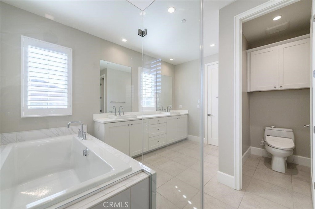 100 Rusina Irvine, CA 92602 - Photo 28 of 46 a bathroom with a bathtub sink mirror and toilet