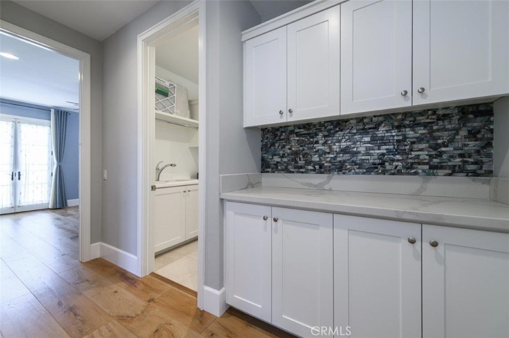 100 Rusina Irvine, CA 92602 - Photo 30 of 46 a kitchen with white cabinets and white appliances