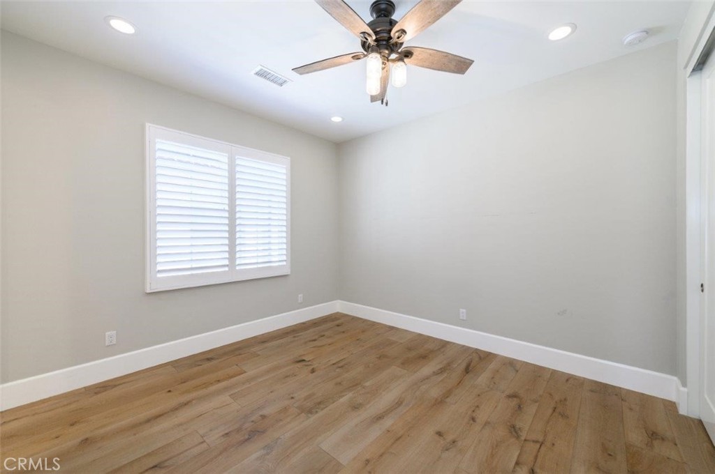 100 Rusina Irvine, CA 92602 - Photo 31 of 46 an empty room with wooden floor and windows