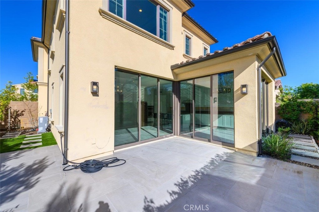 100 Rusina Irvine, CA 92602 - Photo 38 of 46 a view of backyard with large windows and a large tree