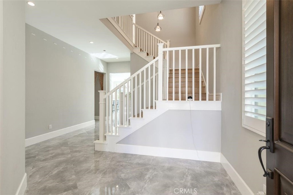 100 Rusina Irvine, CA 92602 - Photo 6 of 46 a view of entryway with stairs and a window
