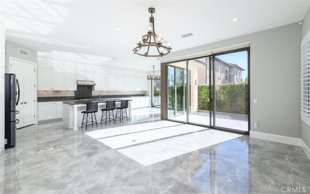 100 Rusina Irvine, CA 92602 - Photo 9 of 46 a very nice looking room with a large window and chandelier