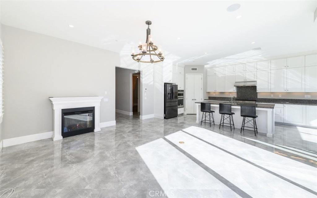 100 Rusina Irvine, CA 92602 - Photo 10 of 46 a living room with furniture a fireplace and kitchen view