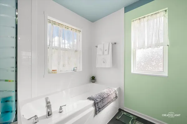 a bath room with a bed and a window