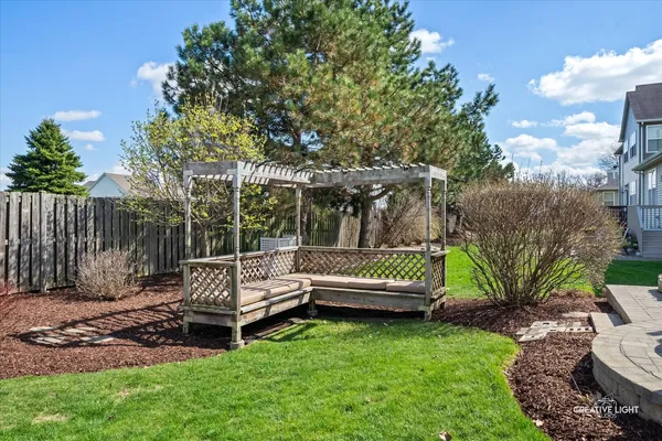 a view of a house with backyard and sitting area