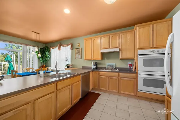 a kitchen with a sink stove and cabinets