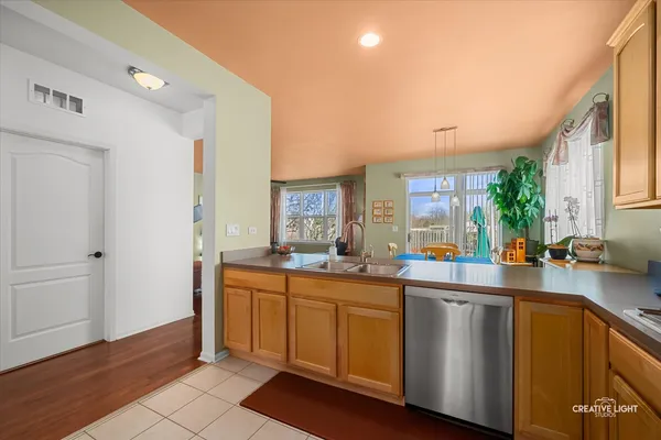 a kitchen with a sink a window and cabinets