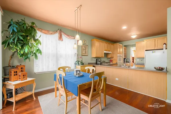 a dining room with furniture and a potted plant